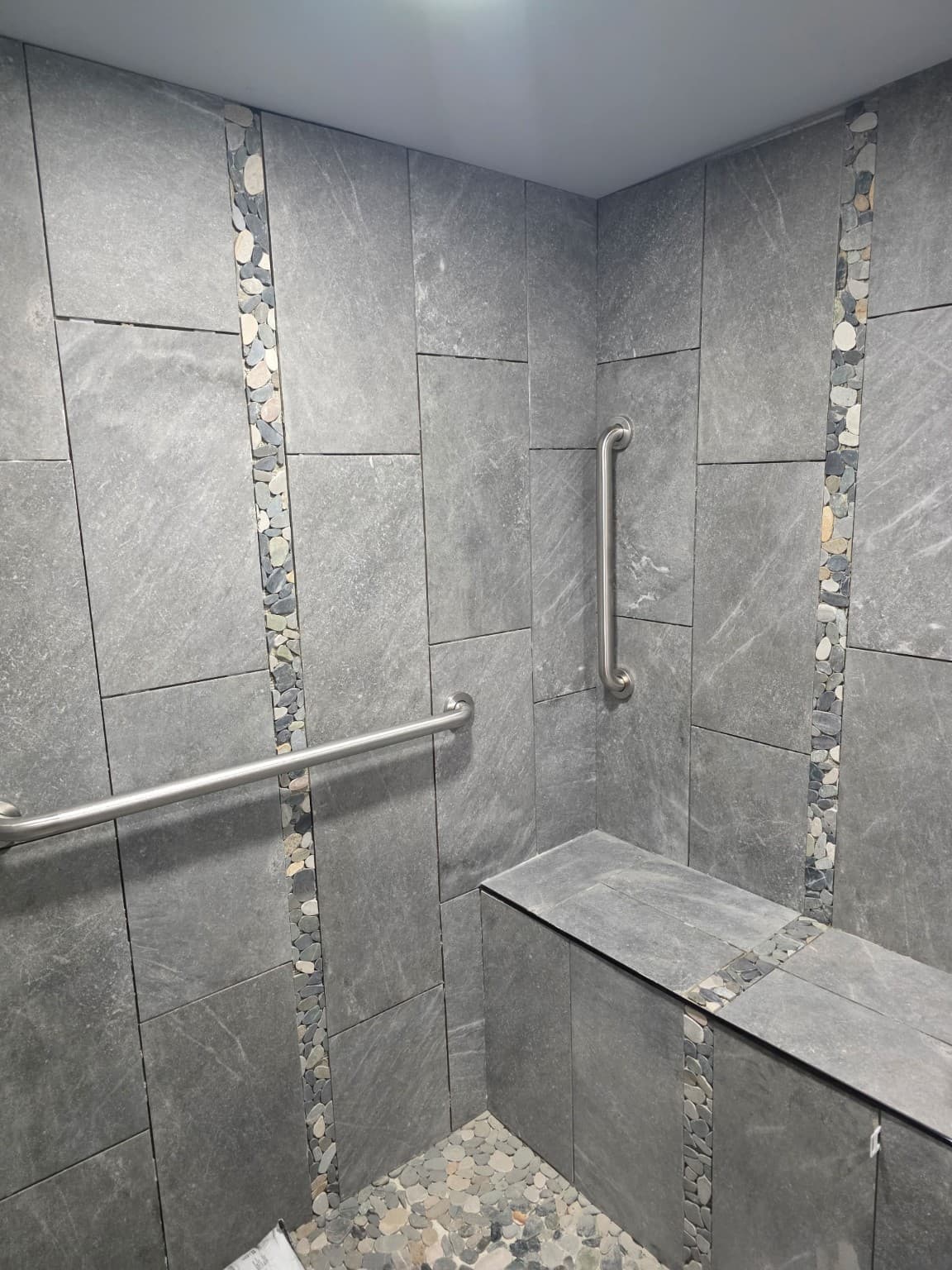 Tile shower bench and stone accents